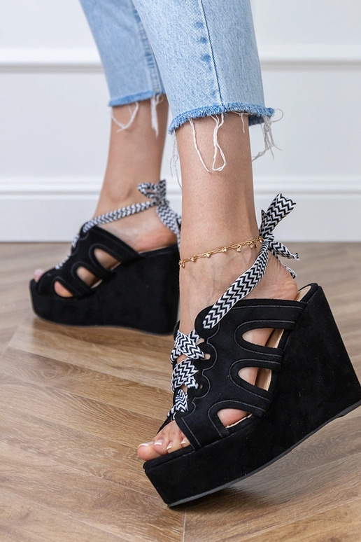 Black sandals on a platform with a decorative lace Lakota