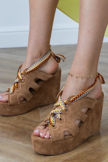 Brown sandals on a platform with a decorative lace Lakota
