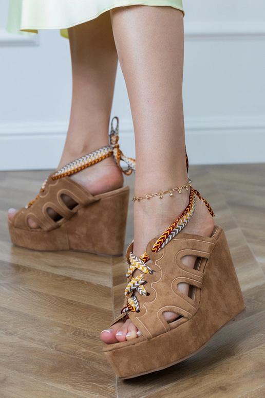 Brown sandals on a platform with a decorative lace Lakota