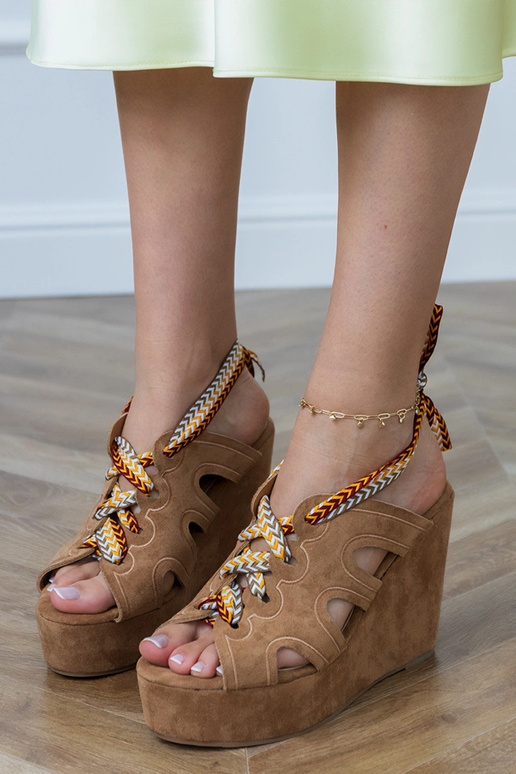 Brown sandals on a platform with a decorative lace Lakota