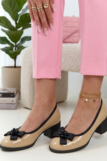 Sand-colored leather patent pumps on a column Cambell