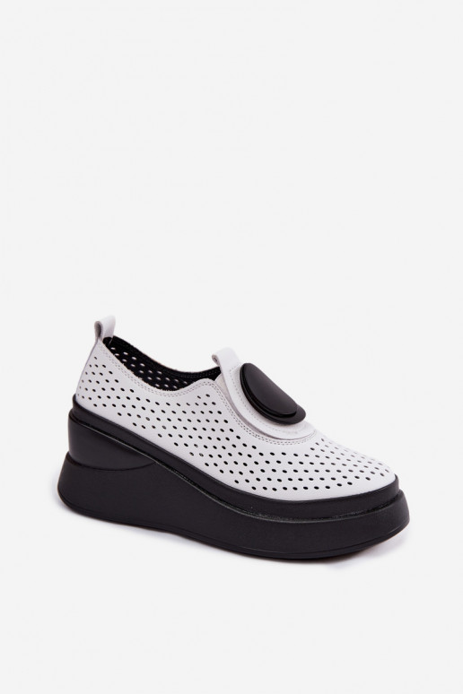 White women's shoes with cut-out elements and decorative platform