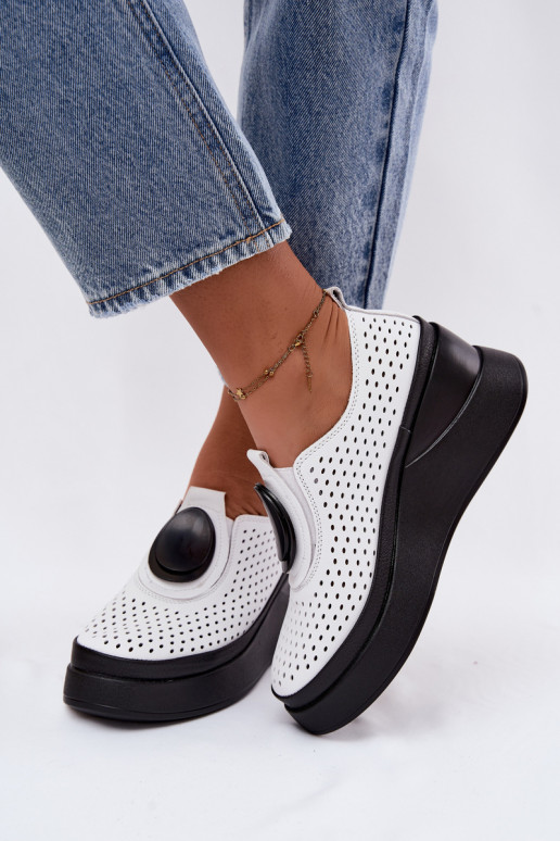 White women's shoes with cut-out elements and decorative platform