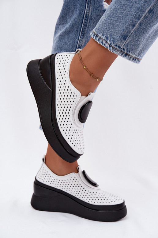 White women's shoes with cut-out elements and decorative platform