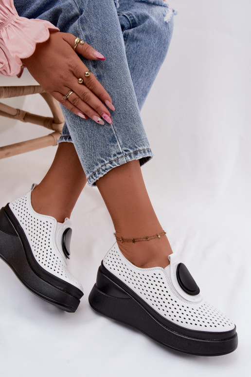 White women's shoes with cut-out elements and decorative platform