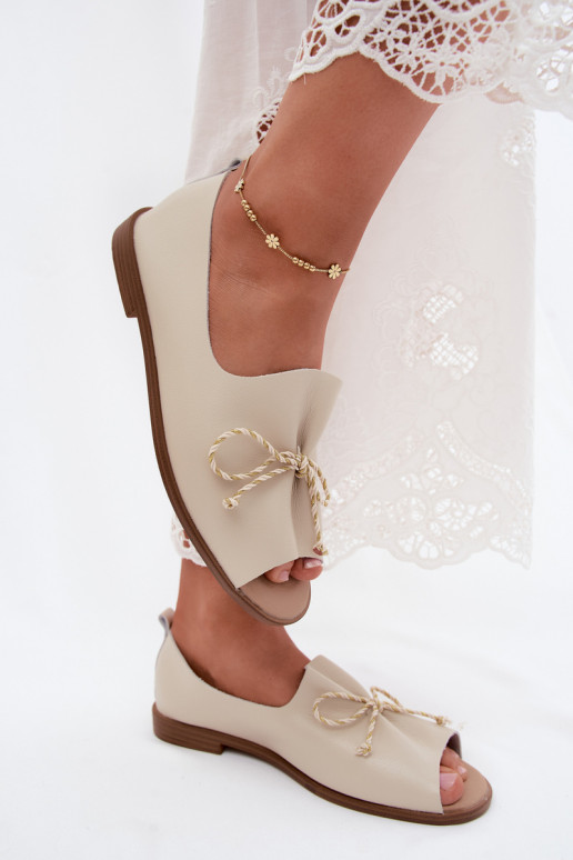 Sand colored women's sandals with decorative laces and shiny finish made of faux leather Coltrania