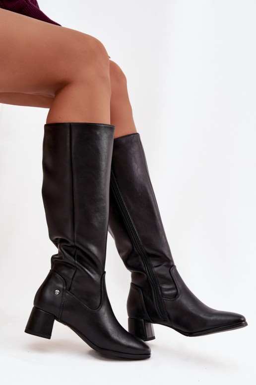 Black insulated women's over-the-knee boots made of leather with heels